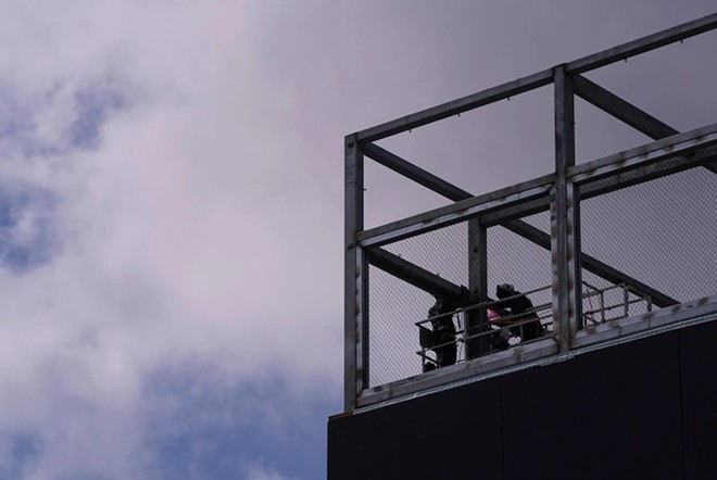 Construction employees work through the late-morning heat on the top floor of a new building in Austin’s West Campus neighborhood on July 6, 2023. - Texas Tribune / Joe Timmerman