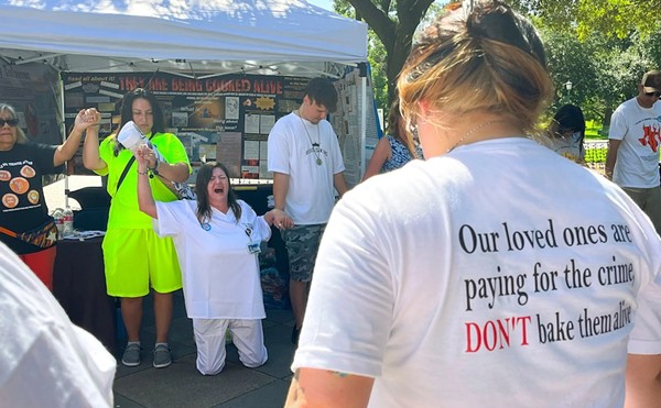 Tona Southards, whose 36-year-old son died in a Texas prison during the June 2023 heat wave, falls to her knees as she leads a prayer circle outside the Texas Capitol. Southards and other prison rights advocates called for Gov. Greg Abbott to call a special session to install air conditioning in Texas prisons.