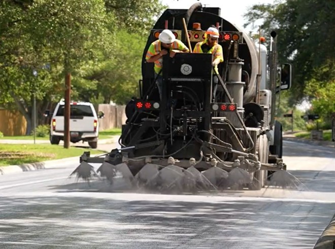 A truck sprays cool pavement, which is a reflective material that reduces the amount of heat absorbed by the pavement. - Screenshot / @COSAGOV on Twitter