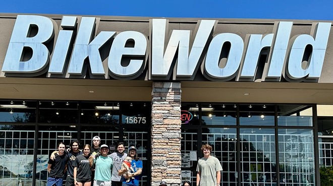 Bike World employees stand in front of the chain's U.S. Highway 281 location prior to its July 10 closure.