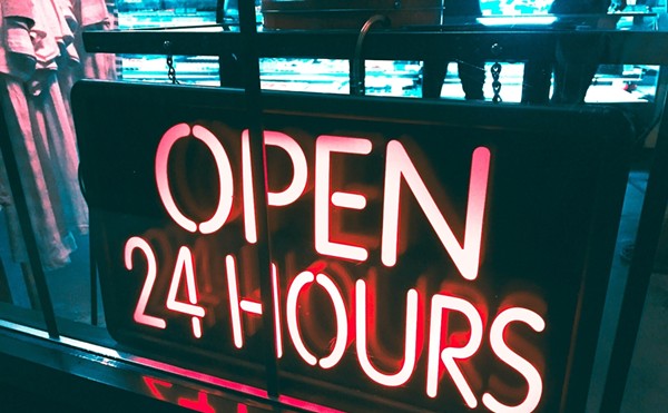 A neon "open 24 hours" sign.