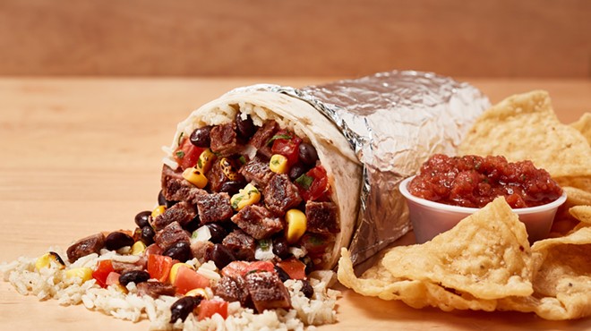 A Freebirds' steak burrito with chips and salsa