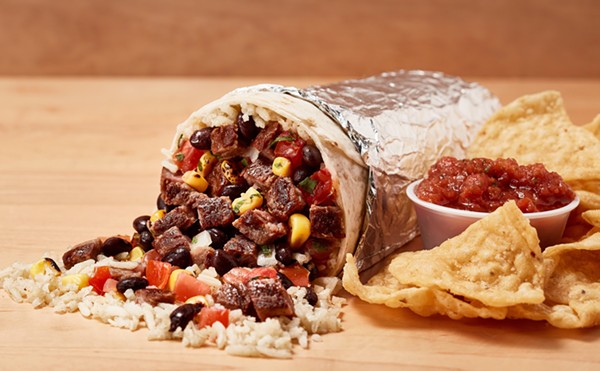 A Freebirds' steak burrito with chips and salsa