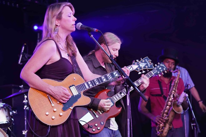 In 2010, Susan Tedeschi and Derek Trucks combined their solo acts into the Tedeschi Trucks Band. - Shutterstock / S. Kuelcue