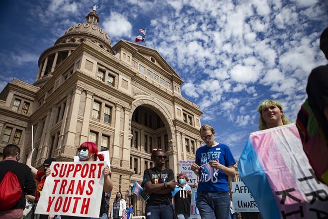 People gather in front of the Texas Capitol during a protest against bills limiting transgender kids' access to puberty blockers and hormone treatments in March. - Texas Tribune / Lauren Witte