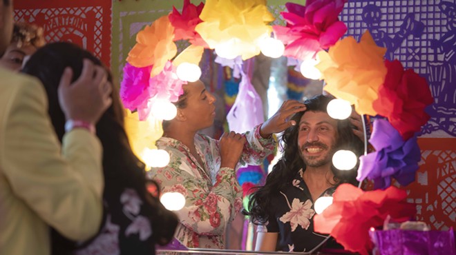 Del Rio Mayor Bruno Lozano (right) tries on a wig in preparation for his drag performance.